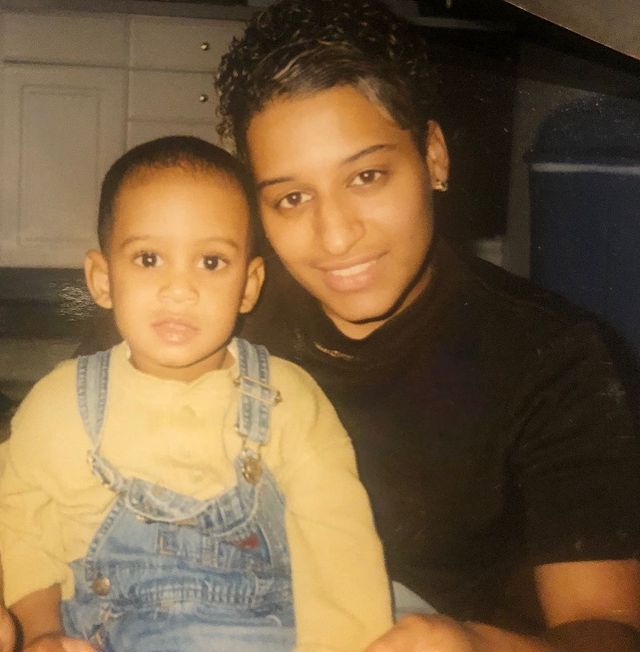 Siddiq Saunderson in his childhood wearing yellow t-shirt, and blue dungaree with his mother in a black t-shirt.